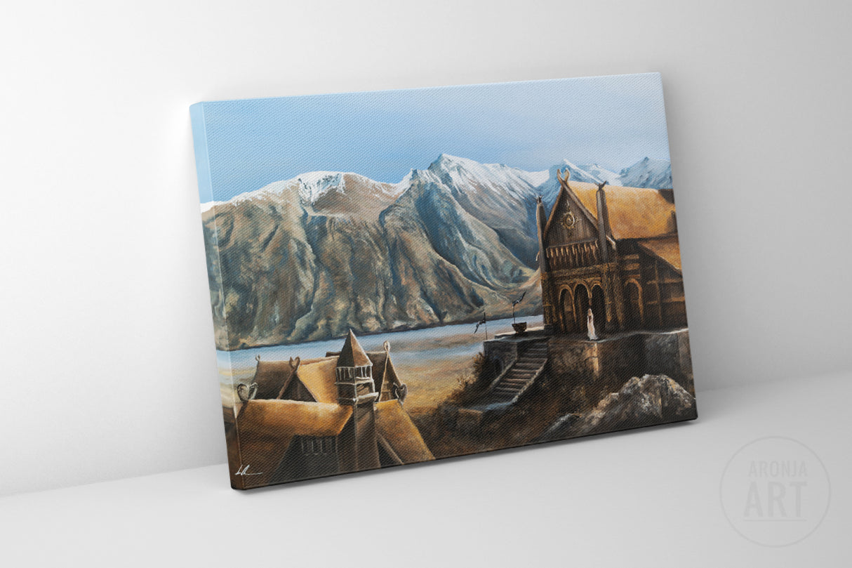 A hand-painted fantasy landscape canvas print showing a detailed golden hall structure by a lake with towering snow-capped mountains in the background, titled The Golden Hall - (Print).