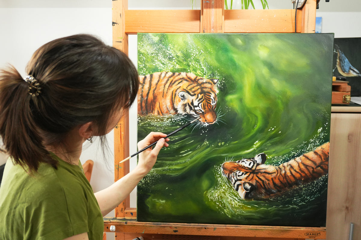 fantasy art painting, woman using a brush on a canvas with tiger faces and green waves