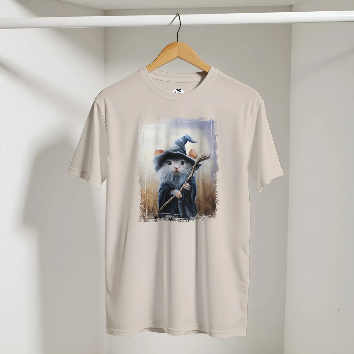 Mousedalf T-shirt featuring fantasy art of a small mouse dressed as a wizard holding a staff, set against a mystical background, blending charming wildlife and mythical themes.
