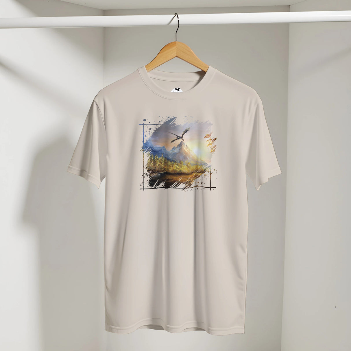 Rift T-shirt featuring a fantasy art design of a dragon flying over a mythical mountain landscape with birds, printed on a light beige fabric.