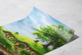 The Hole In The Ground - Print depicting a vibrant fantasy landscape with lush green hills, a large tree, and quaint hobbit-style round door homes under a bright blue sky.
