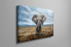 Elephant (Print) is a detailed fine art print depicting a majestic elephant standing in a vast, natural landscape under a dramatic cloudy sky.