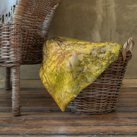 The Bridge - Blanket fantasy art throw blanket in yellow and green on a wicker chair