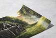 The Road Goes On (Print) showing a hand-painted fantasy landscape with a cart pulled by a horse moving through a misty, lush green forest path under dappled sunlight.